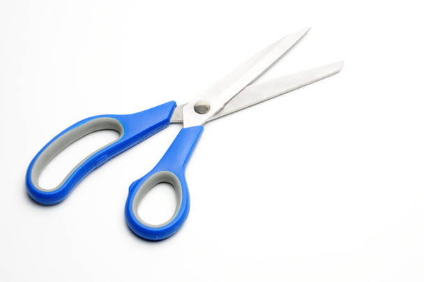Scissors with a blue handle for tailors on an isolated white background - Fotó, kép