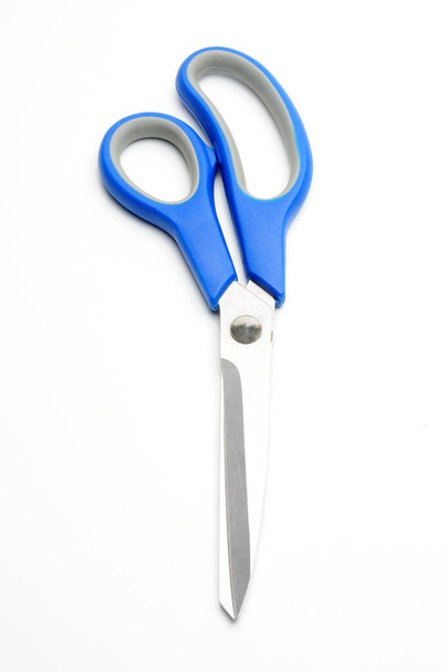 Scissors with a blue handle for tailors on an isolated white background - Photo, Image