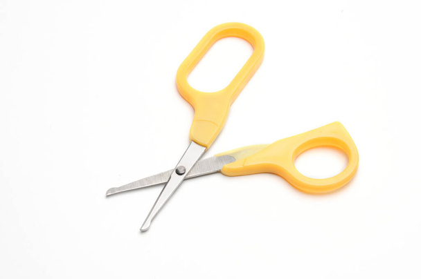 Yellow baby scissors on an isolated white background/Blue baby scissors on an isolated white background - Fotoğraf, Görsel