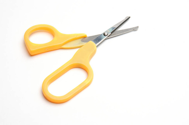 Yellow baby scissors on an isolated white background/Blue baby scissors on an isolated white background - Zdjęcie, obraz