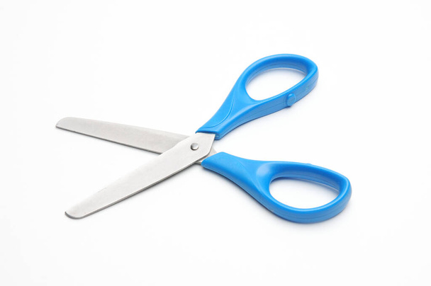 Blue baby scissors on an isolated white background/Blue baby scissors on an isolated white background - Foto, Imagen