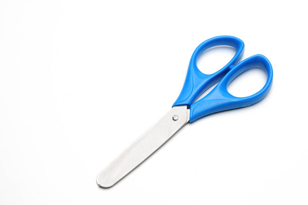 Blue baby scissors on an isolated white background/Blue baby scissors on an isolated white background - Fotó, kép