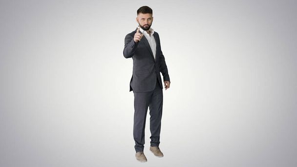 Businessman with a beard showing gestures Finger up, thumbs up o - Zdjęcie, obraz