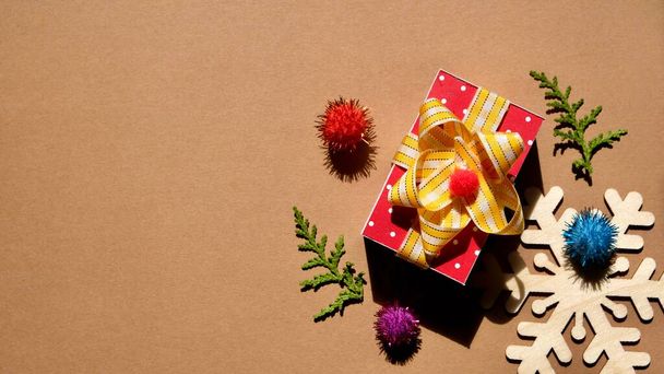 Christmas composition. Christmas gifts and toys on a brown background. - Photo, image