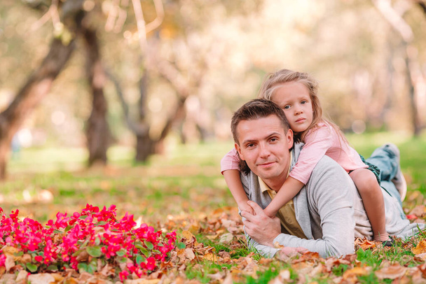 Family of dad and kid on beautiful autumn day in the park - Photo, Image