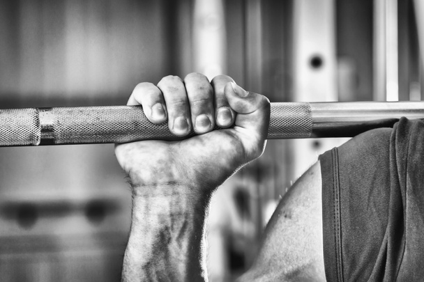 Sportsman's hand pushing barbell - Photo, Image