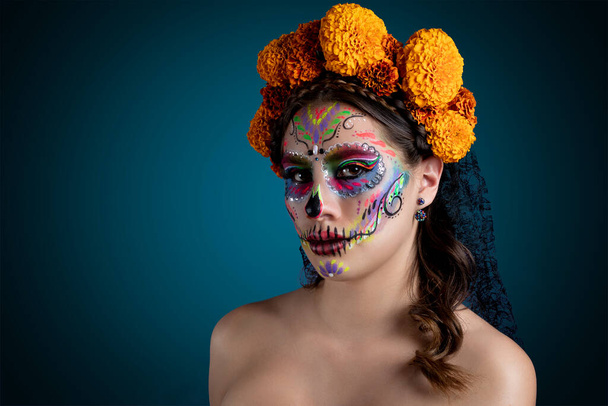Catrina face with flowers and blue background - Photo, Image