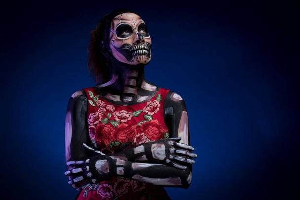 Skull with red dress and blue background - Photo, Image