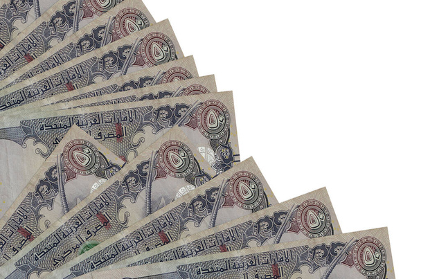 50 billetes dirhams de los Emiratos Árabes Unidos se encuentra aislado sobre fondo blanco con espacio de copia apilados en el ventilador de cerca. Concepto de día de pago u operaciones financieras - Foto, imagen