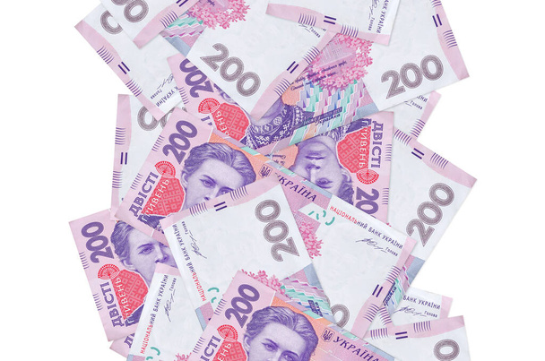 200 ukraińskich banknotów hrywien lecących samotnie na białym. Wiele banknotów spadających z białą przestrzenią po lewej i prawej stronie - Zdjęcie, obraz