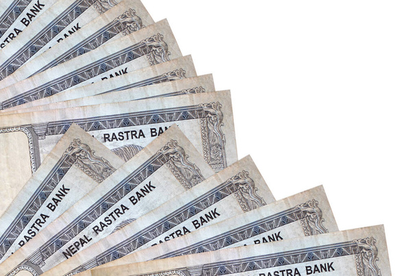 500 Nepalese roepies biljetten ligt geïsoleerd op witte achtergrond met kopieerruimte gestapeld in ventilator close-up. Begrip "betaaldag" of financiële transacties - Foto, afbeelding