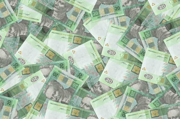 20 Oekraïense hryvnias biljetten liggen in grote stapel. Rich life conceptuele achtergrond. Groot bedrag aan geld - Foto, afbeelding