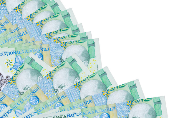 1 Roemeense leu biljetten ligt geïsoleerd op witte achtergrond met kopieerruimte gestapeld in ventilator close-up. Begrip "betaaldag" of financiële transacties - Foto, afbeelding