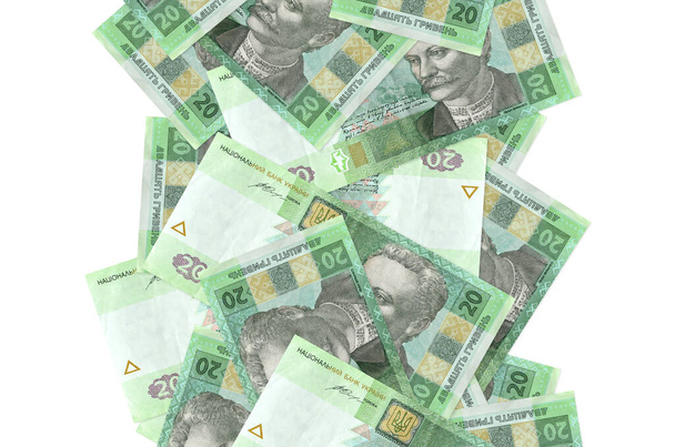 20 ukrajinských bankovek za hřivnu letících dolů izolovaných na bílém. Mnoho bankovek padajících s bílou kopií prostoru na levé a pravé straně - Fotografie, Obrázek
