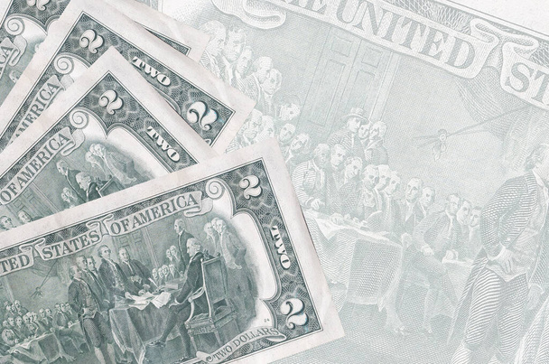 2 купюры в долларах США лежат в стопке на фоне большой полупрозрачной банкноты. Аннотация бизнес-фон с копировальным пространством - Фото, изображение