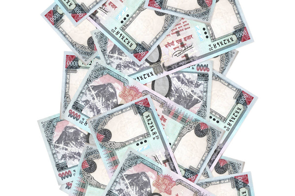 1000 Nepalese rupees bills flying down isolated on white. Many banknotes falling with white copy space on left and right side - Photo, Image