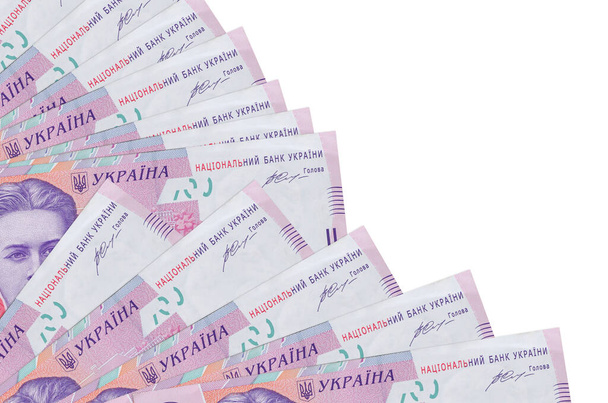 200 ukrajinské hryvnias bankovky leží izolované na bílém pozadí s kopírovacím prostorem naskládané v ventilátoru zblízka. Koncept výplatní doby nebo finanční operace - Fotografie, Obrázek