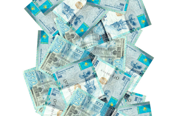 500 Kazakhstani tenge bills flying down isolated on white. Many banknotes falling with white copy space on left and right side - Photo, Image