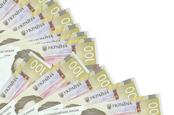 100 Ukrainian hryvnias bills lies isolated on white background with copy space stacked in fan close up. Payday time concept or financial operations - Photo, Image