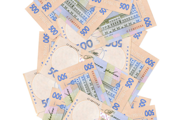 500 ukrán hrivnya bankjegy repül le elszigetelve a fehéren. Sok bankjegy esik fehér fénymásolási hellyel a bal és a jobb oldalon - Fotó, kép