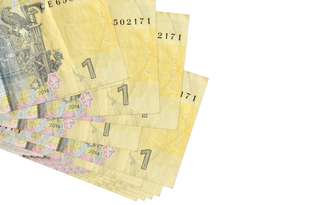 1 billetes de hryvnia ucraniano se encuentra en un pequeño manojo o paquete aislado en blanco. Mockup con espacio de copia. Concepto de negocio y cambio de divisas - Foto, imagen