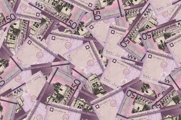 50 Dominican pesos bills lies in big pile. Rich life conceptual background. Big amount of money - Photo, Image