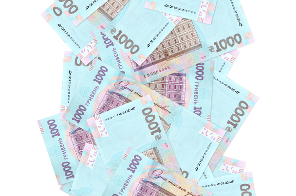 1000 Ukrainian hryvnias bills flying down isolated on white. Many banknotes falling with white copy space on left and right side - Photo, Image