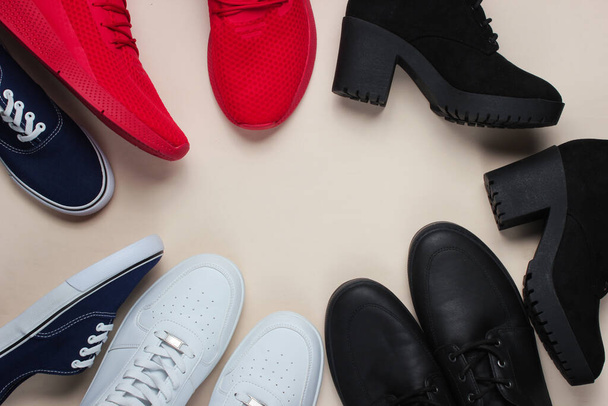 Lot of pairs of shoes on a white background. Minimalistic fashion concept. Top view. Copy space - Φωτογραφία, εικόνα