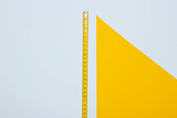 Industrial ruler on yellow white background.  Top view - 写真・画像