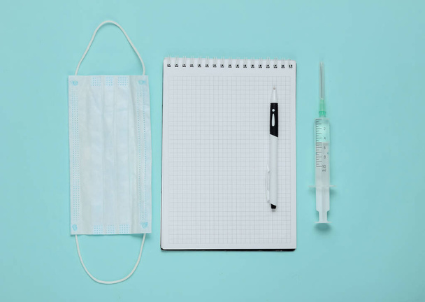 Notepad with medical supplies on a blue background. Medical still life. Top view - Fotografie, Obrázek