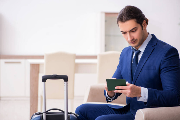 Young businessman holding passport preparing for trip - Photo, Image