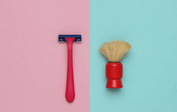 Razor, shaving brush on a pastel pink-blue background. Top view - Photo, Image