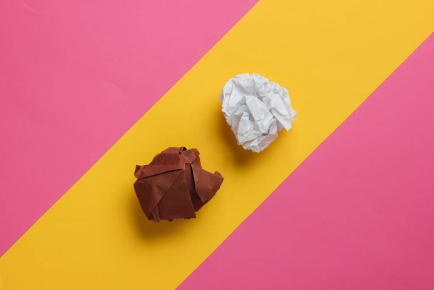 crumpled balls of paper on a yellow-pink pastel background. Top view - Фото, изображение