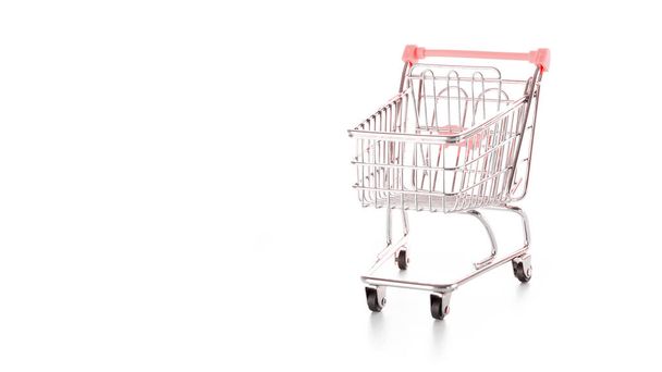 Products cart. Food shopping basket for retail market. Empty trolley cart for supermarket isolated on white background. Creative idea for shopping online, summer sale, supermarket - Photo, Image