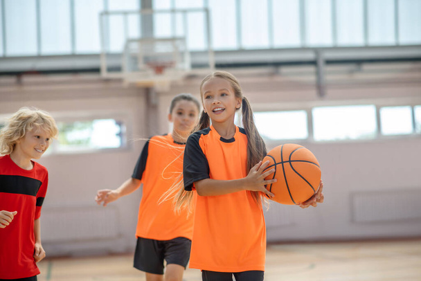 Kids in bright sportswear having basketball game - Fotó, kép