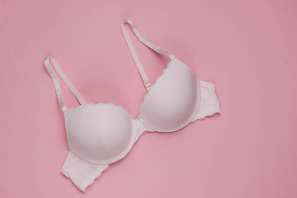 Stylish bra on a pink pastel background. Top view. Beauty and fashion minimalistic still life - Photo, Image