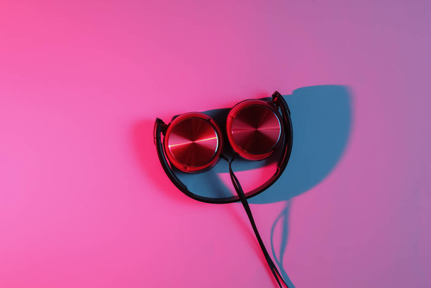 Ενσύρματα ακουστικά με νέον μπλε-κόκκινο φως κλίση. Ρετρό κύμα, ποπ κουλτούρα του '80. Άνω όψη - Φωτογραφία, εικόνα