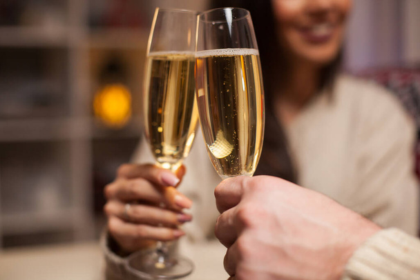 Close up of champagne glasses holded by cheerful couple - Photo, Image