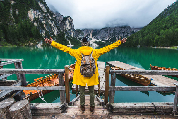 Traveler visiting an alpine lake at Braies, Italy - Tourist with hiking outfit having fun on vacation during autumn foliage - Concepts about travel, lifestyle and wanderlust - Фото, зображення