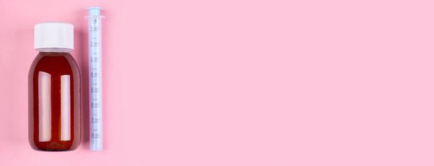 Baby antipyretic bottle on pink background. - Photo, Image