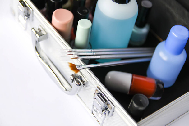 Make up case with cosmetics on a white background. Nail polishes, nail polish remover and brushes - Фото, изображение