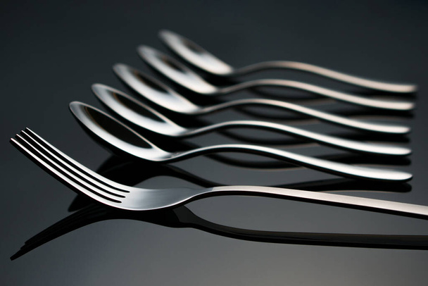 Fork and teaspoons lie on a glass table - Valokuva, kuva