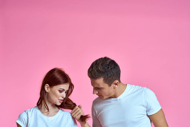 enamored man and woman hugging each other on a pink background cropped with Copy Space family portrait - Fotografie, Obrázek