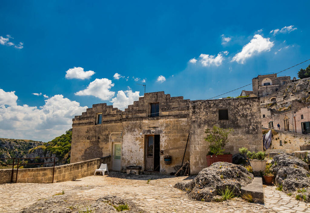 August 8, 2020 - Matera, Basilicata, Italy - A glimpse of the ancient city, with the typical stone and brick houses of the old town of Matera, in the Sasso Caveoso and Barisano. - 写真・画像