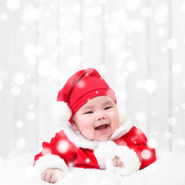 asian children cute or kid and baby wearing santa claus suit with fun or happy and smile in the winter and snow bokeh on white wood wall background for christmas or xmas and happy new year with space - Photo, Image