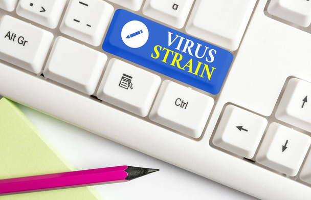 Conceptual hand writing showing Virus Strain. Business photo text Another genetic variant derived from the original microorganism Colored keyboard key with accessories arranged on empty copy space. - Photo, Image