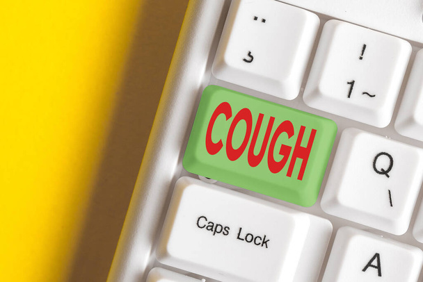 Writing note showing Cough. Business photo showcasing sudden expulsion of air throughout the passages to clear airways Colored keyboard key with accessories arranged on empty copy space. - Photo, Image