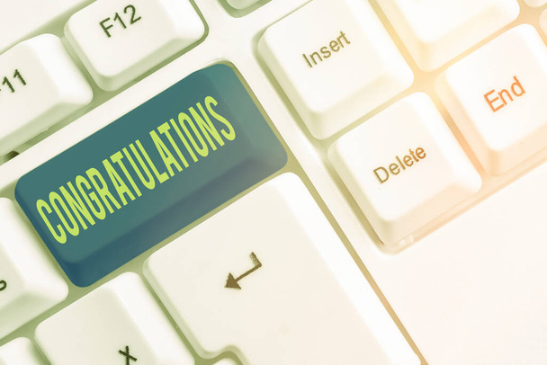 Text sign showing Congratulations. Conceptual photo a congratulatory expression usually used in plural form Different colored keyboard key with accessories arranged on empty copy space. - Photo, Image