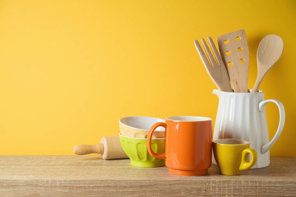 Kitchen utensils and dishware on wooden shelf. Autumn kitchen interior background - 写真・画像