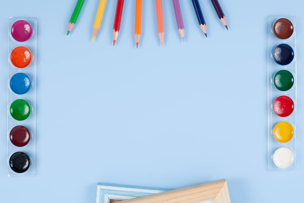 Pencils, watercolor, brush and wood on blue background - Foto, afbeelding